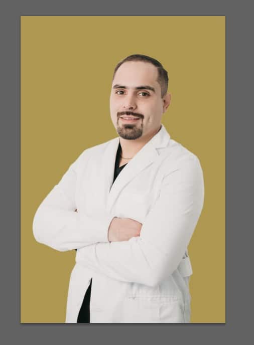 Dr. Sergio Verduzco with arms crossed smiling in labcoat